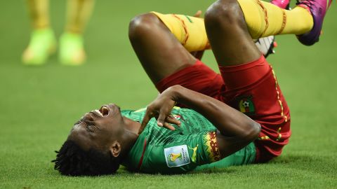 Cameroonian forward Benjamin Moukandjo screams as he lies on the pitch during the game.