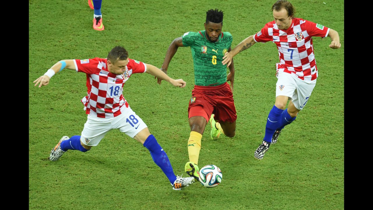 Ivica Olic of Croatia, left, and teammate Ivan Rakitic vie for the ball against Cameroon's Alexandre Song.