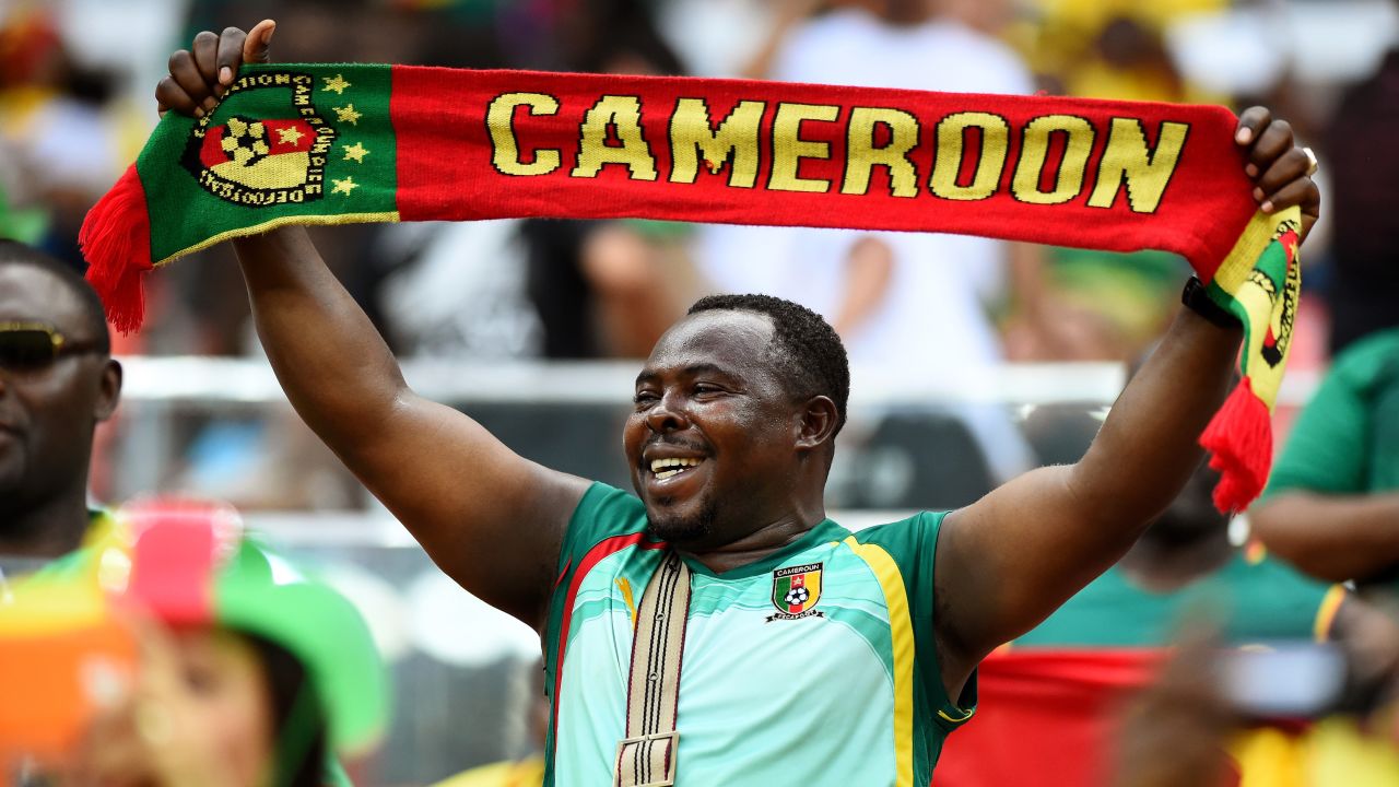 A Cameroon fan shows his support before the game.