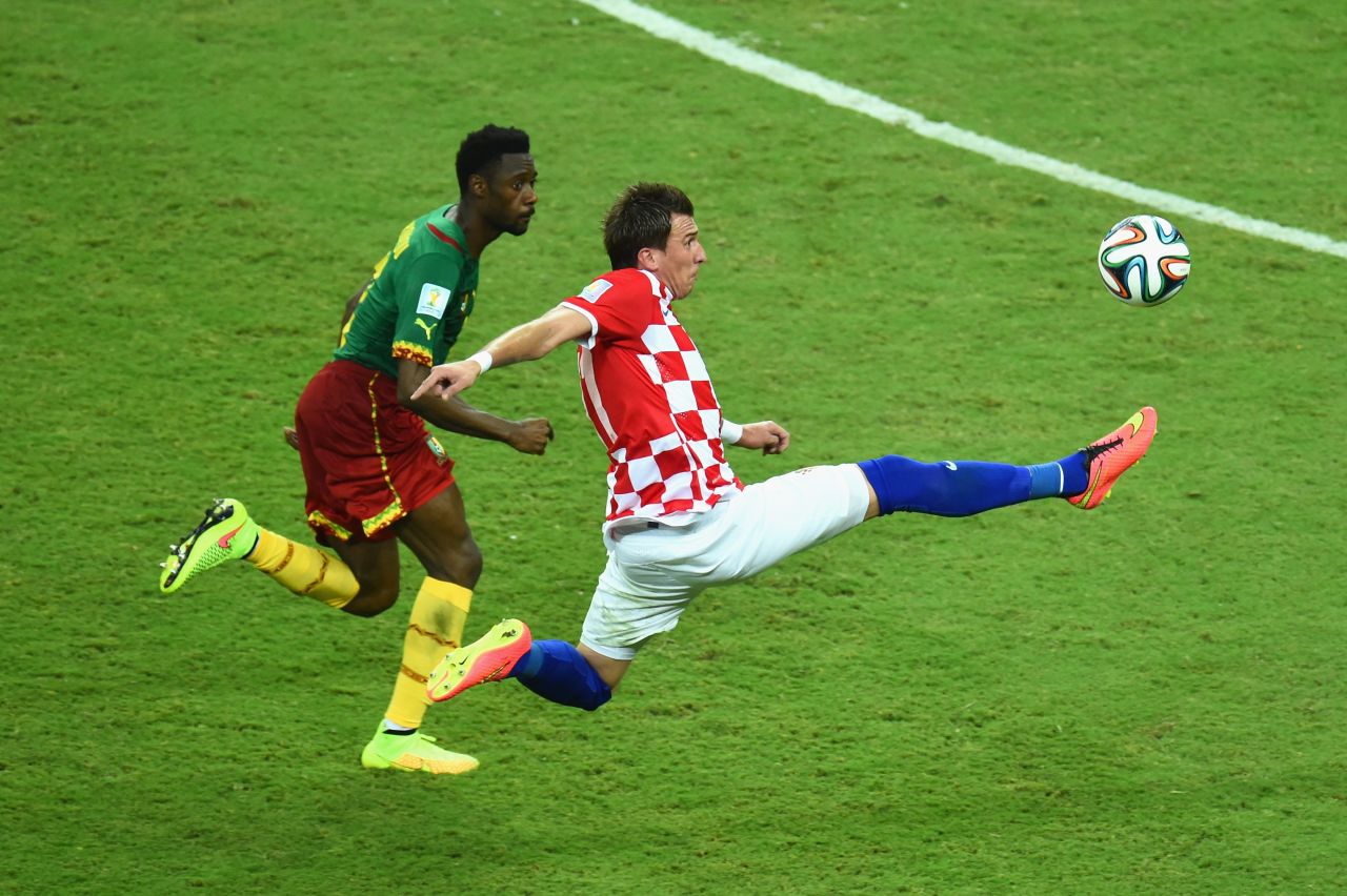 Mario Mandzukic of Croatia competes for the ball with Nicolas N'Koulou of Cameroon.