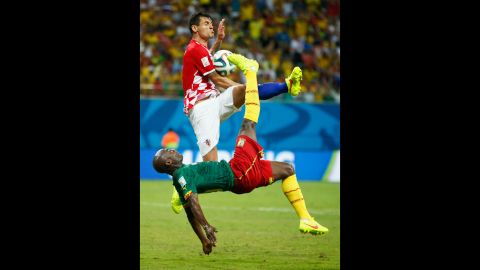 Pierre Webo of Cameroon attempts an overhead kick against Croatia's Dejan Lovren.