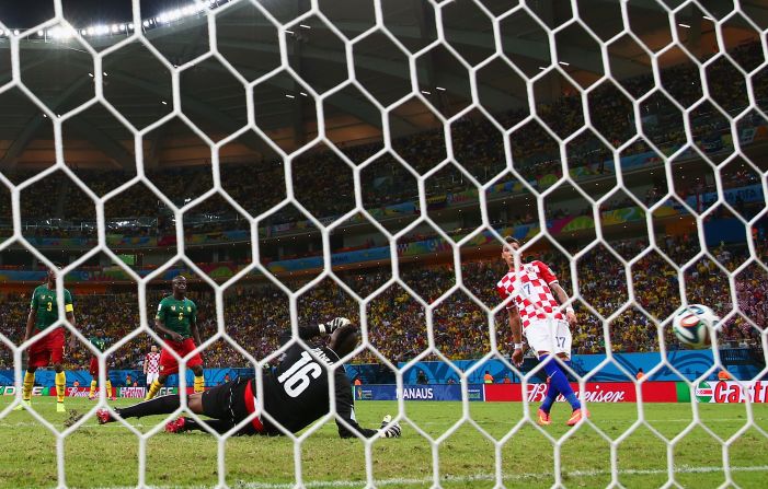 Mario Mandzukic of Croatia scores his second goal past Charles Itandje of Cameroon during a World Cup match Wednesday, June 18, in Manaus, Brazil. Croatia won 4-0, eliminating Cameroon from World Cup contention.