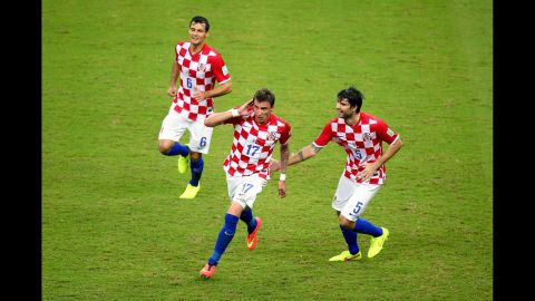 Mandzukic, center, celebrates scoring Croatia's third goal with his teammates Dejan Lovren, left, and Vedran Corluka.