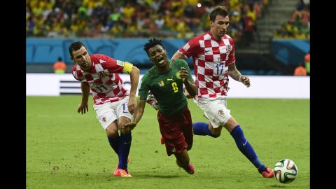 Croatia's Darijo Srna, left, and Mario Mandzukic tackle Cameroon's Benjamin Moukandjo. 