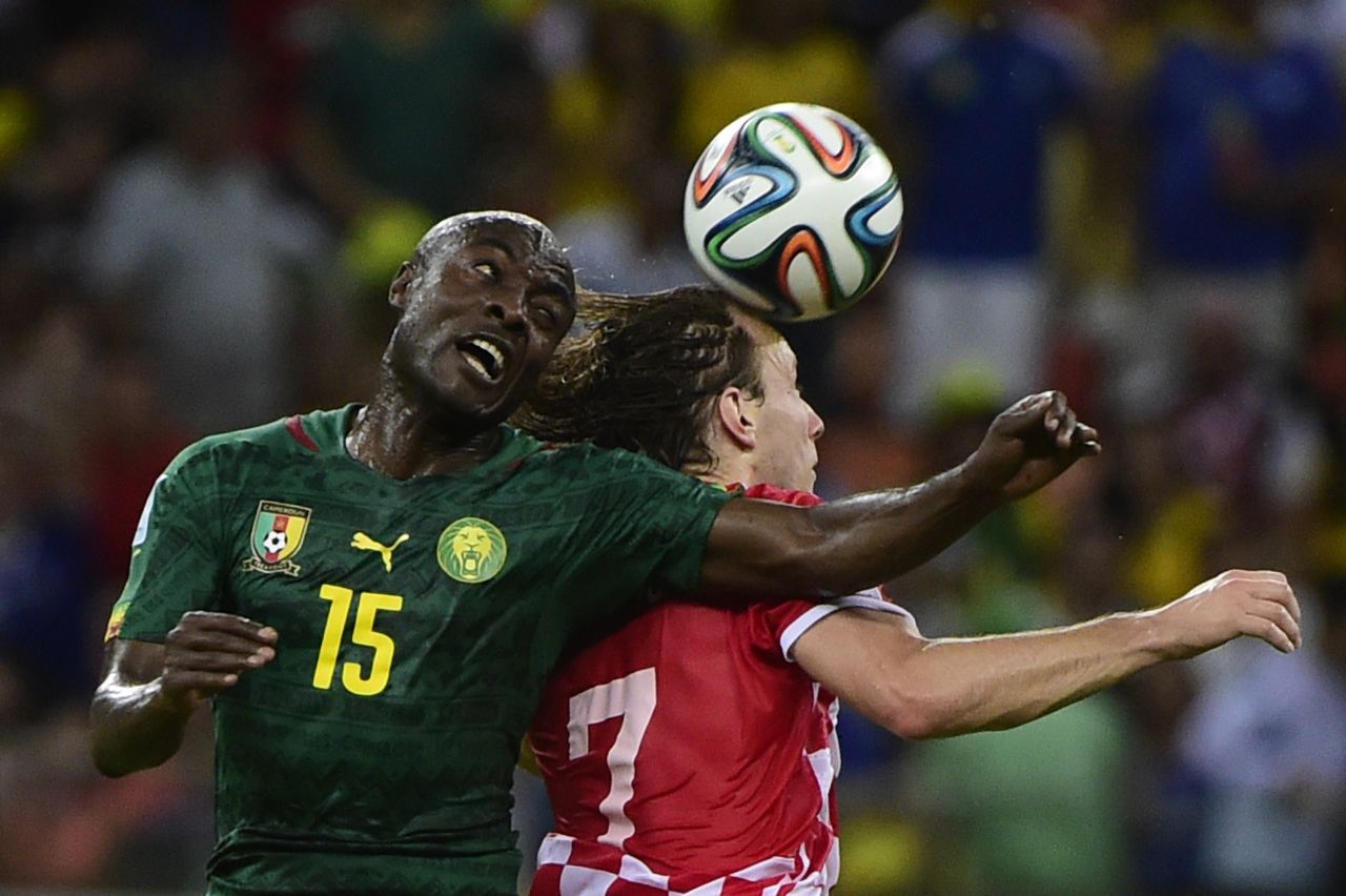 Cameroon's Pierre Webo, left, and Croatia's Ivan Rakitic vie for the ball.