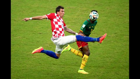 Mario Mandzukic of Croatia takes on Cameroon's Nicolas N'Koulou.
