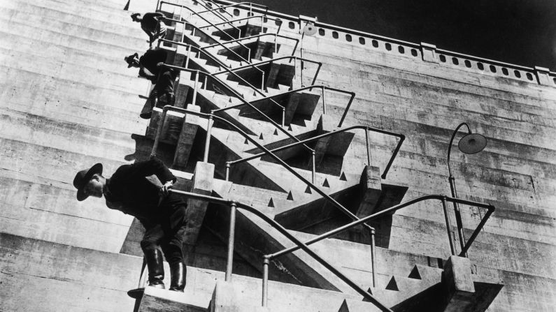Yosemite National Park guards climb the staircase leading to the outlet valves of the O'Shaughnessy Dam, which was authorized by Congress in 1913 and completed in 1938. <a href="index.php?page=&url=http%3A%2F%2Fwww.nps.gov%2Fyose%2Fplanyourvisit%2Fupload%2Fhetchhetchy-sitebull.pdf" target="_blank" target="_blank">The Hetch Hetchy Reservoir</a>, now the largest single body of water in the park, still provides water to residents of San Francisco and the Bay Area.