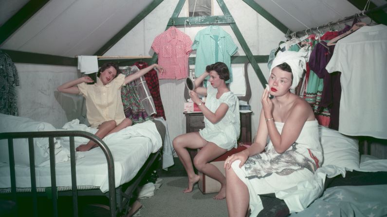 Three young women get ready for work in their three-person tent at  Camp Curry in Yosemite National Park, where they were employed for the summer of 1955.