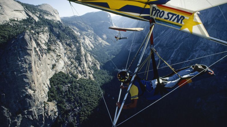 Hang gliders take off over Yosemite Valley from Glacier Point, circa 1985. <a href="index.php?page=&url=http%3A%2F%2Fparkplanning.nps.gov%2FprojectHome.cfm%3FparkID%3D347%26projectID%3D21599" target="_blank" target="_blank">Only advanced rated hang gliding pilots</a> are permitted to fly in the park. 