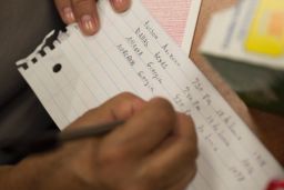 Volunteers help immigrants map out their bus itineraries.