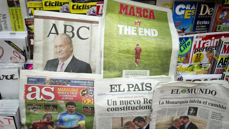 Newspapers in Valencia, Spain, cover the abdication as well as Spain's elimination from the World Cup.