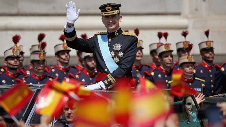 Felipe waves to the crowd as he arrives at the royal palace.