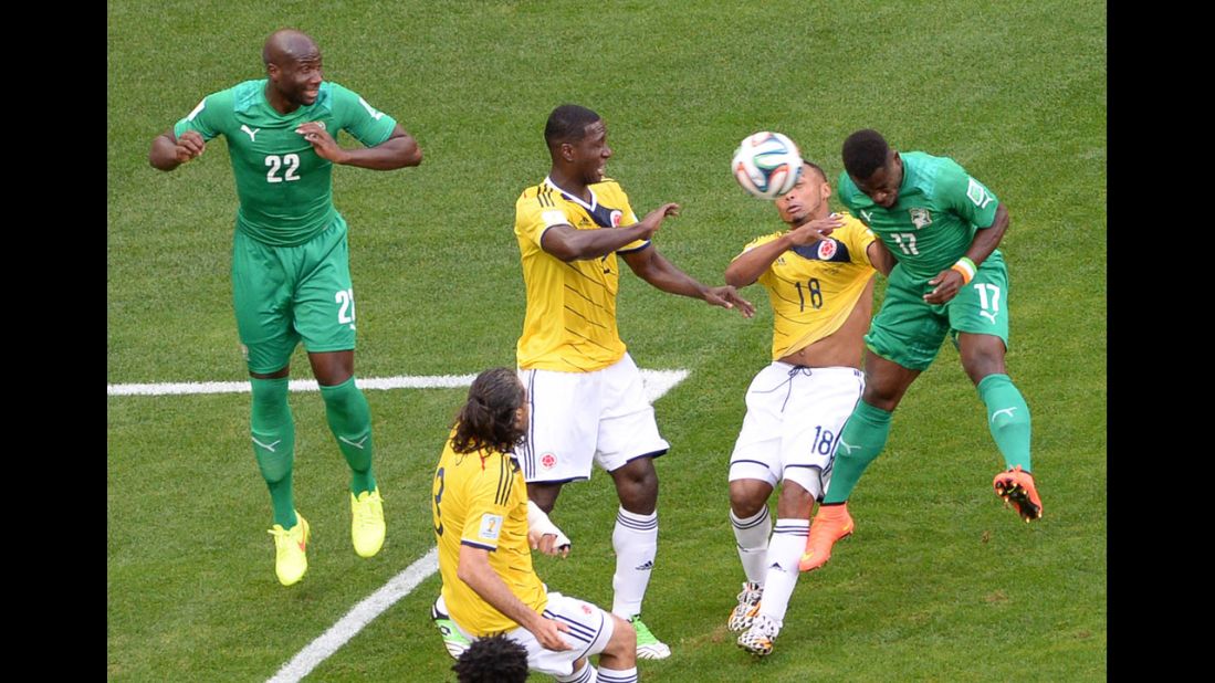Zuniga, second from right, goes for a header along with Ivory Coast defender Serge Aurier.