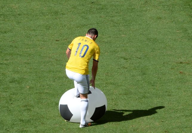 Rodriguez stamps a giant balloon that came onto the field during the match.