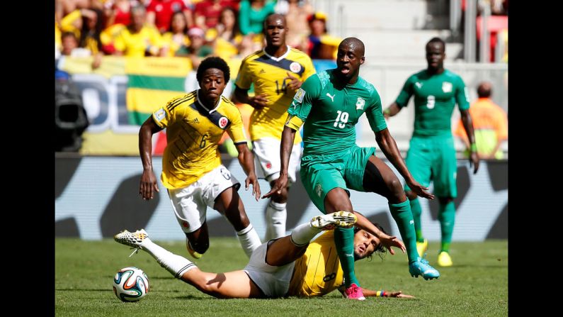 Aguilar slides to tackle Yaya Toure of the Ivory Coast.