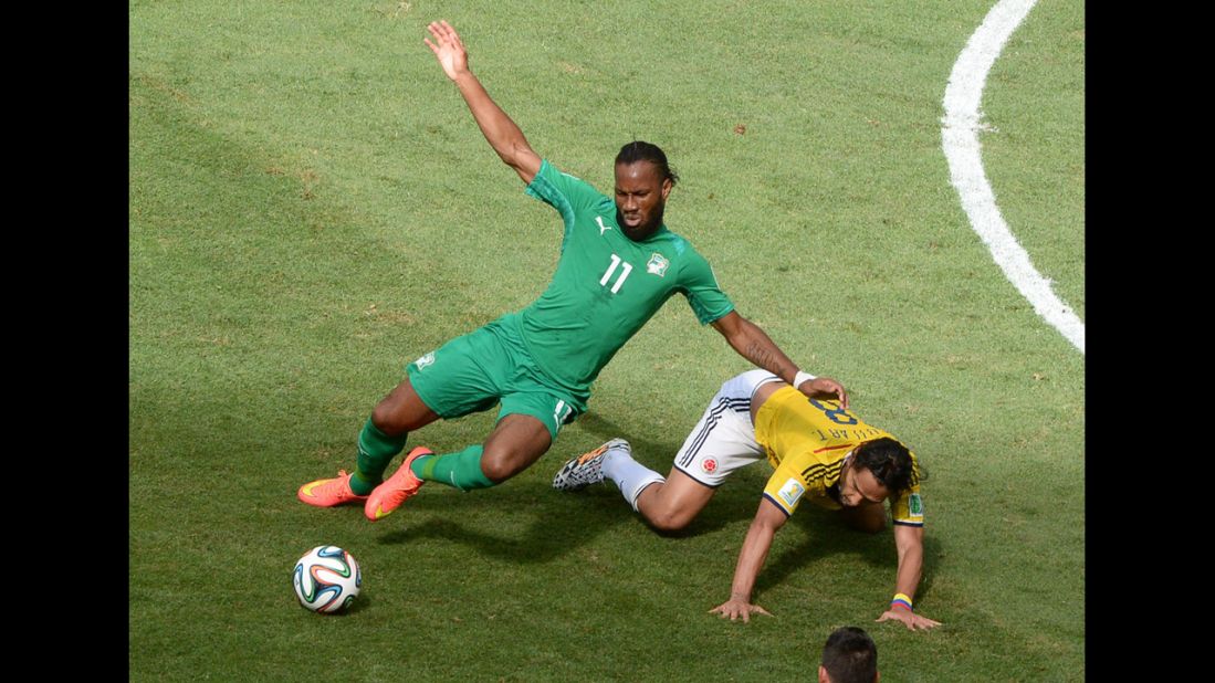 Ivory Coast forward Didier Drogba, left, competes with Colombian midfielder Abel Aguilar.