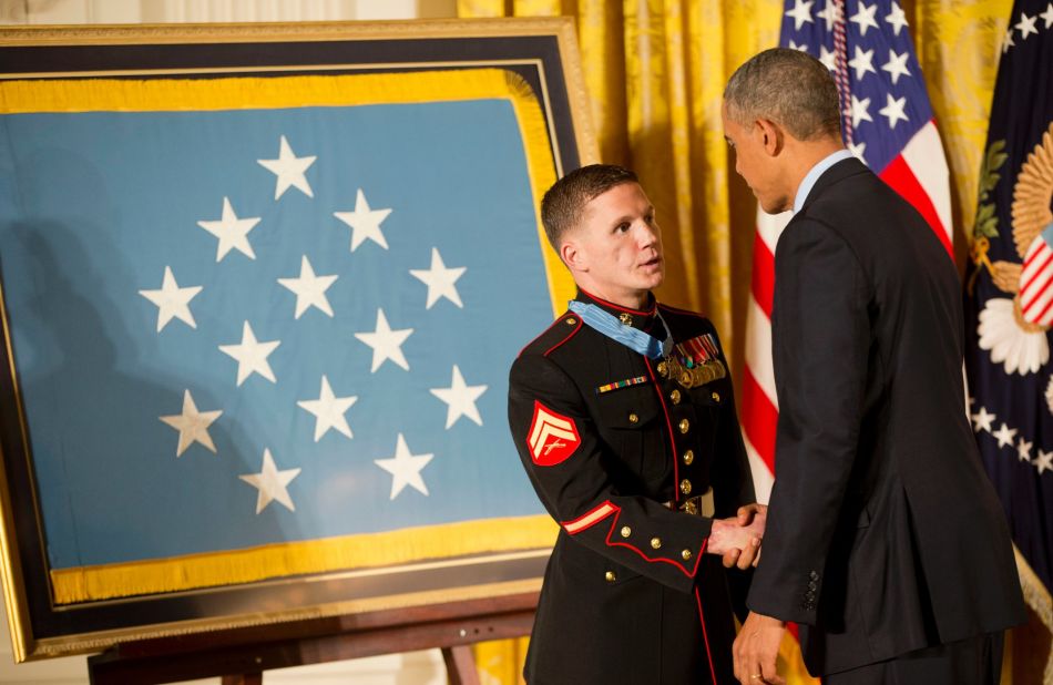 Retired Marine Cpl. Kyle Carpenter shakes hands with Obama as he receives the Medal of Honor on June 19. While serving in Afghanistan, Carpenter used his body to shield a fellow Marine from a grenade blast on November 21, 2010.
