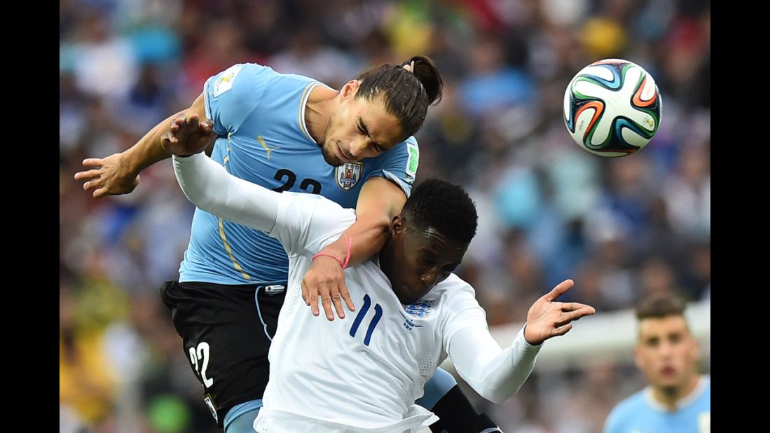 Caceres heads the ball away from England's Danny Welbeck.