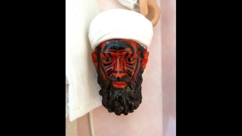 The final version had the faces of the figures painted with a heat-dissolving material, designed to peel off and reveal a demon bin Laden.