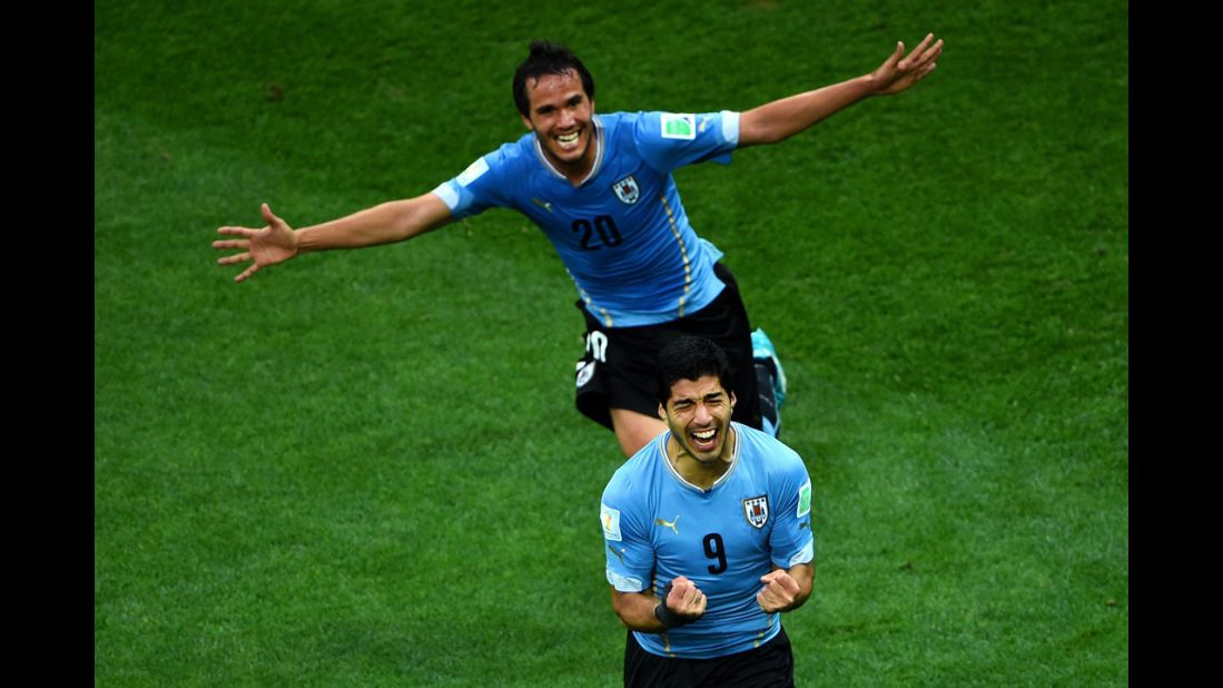 Suarez, front, and teammate Alvaro Gonzalez celebrate Suarez's first goal.