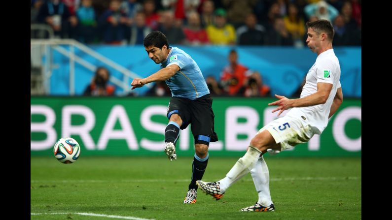 Uruguayan forward Luis Suarez drills a shot to score a late second-half goal and defeat England 2-1 in a World Cup match Thursday, June 19, in Sao Paulo, Brazil. Suarez had both of Uruguay's goals.