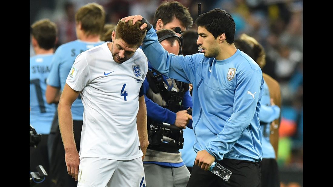 England captain Steven Gerrard, left, is consoled by Uruguay forward Luis Suarez after Uruguay won 2-1 in a World Cup match in Sao Paulo, Brazil. Gerrard and Suarez are teammates for their professional club, Liverpool.