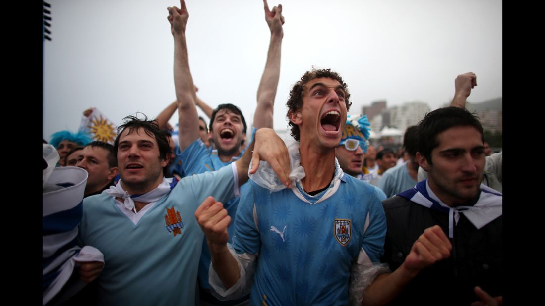 Uruguay fans at Brazil's Copacabana beach celebrate Suarez's first goal.