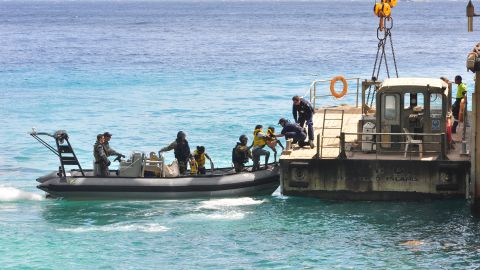 A file image of suspected asylum seekers at Flying Fish Cove, Christmas Island, after being intercepted and escorted in by the Australian Navy, August 2013.