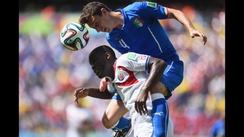 Campbell and Matteo Darmian of Italy compete for a header.