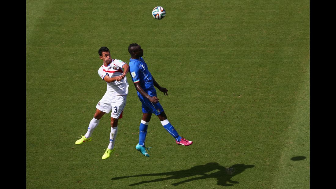 Balotelli and Gonzalez go up for a header in the first half.