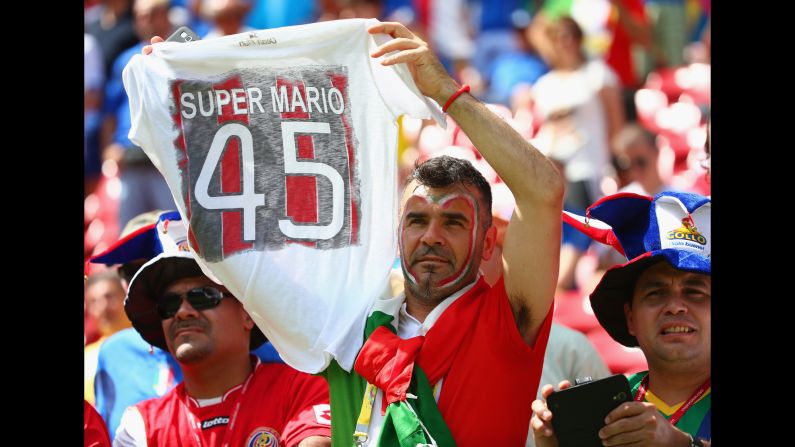 An Italy fan holds up a T-shirt honoring Balotelli before the match. <a href="index.php?page=&url=http%3A%2F%2Fwww.cnn.com%2F2014%2F06%2F19%2Ffootball%2Fgallery%2Fworld-cup-0619%2Findex.html">See the best World Cup photos from June 19.</a>