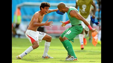 Yeltsin Tejeda of Costa Rica, left, celebrates with teammate Patrick Pemberton after they defeated Italy 1-0 during a World Cup match in Recife, Brazil. With the victory, Costa Rica clinched a spot in the next round of the tournament.