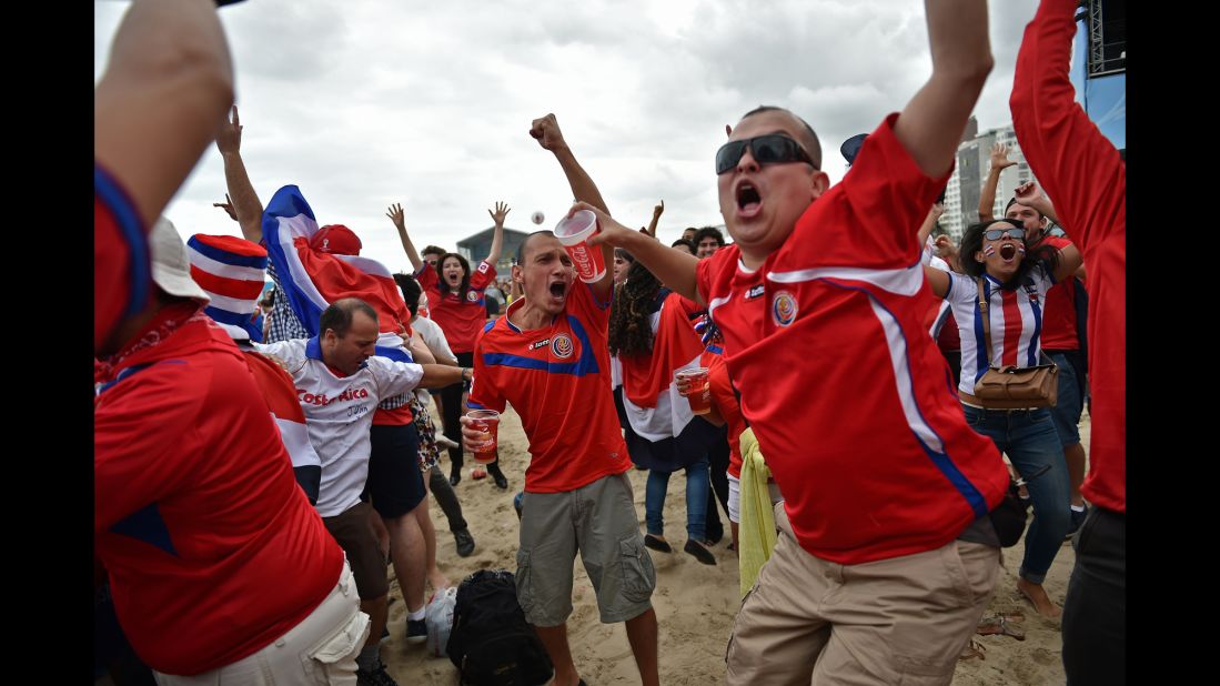 Costa Rica fans react while watching from a beach in Rio de Janeiro.