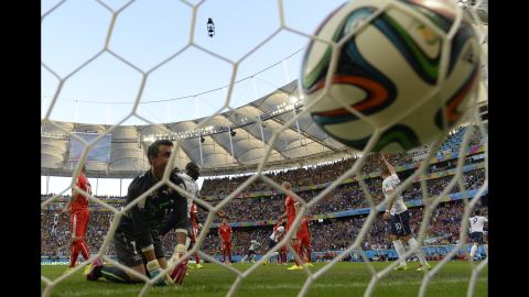 Benaglio kneels near the net after French forward Olivier Giroud, far right, headed in a goal to open the scoring.