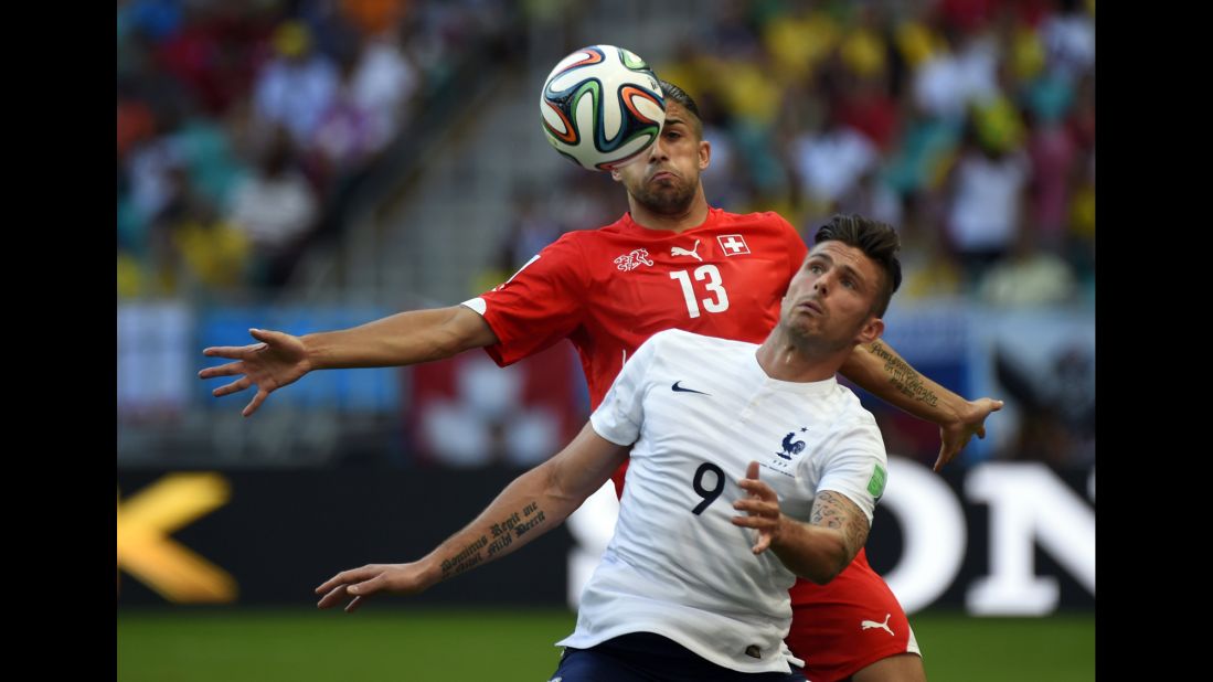 Switzerland defender Ricardo Rodriguez challenges Giroud.