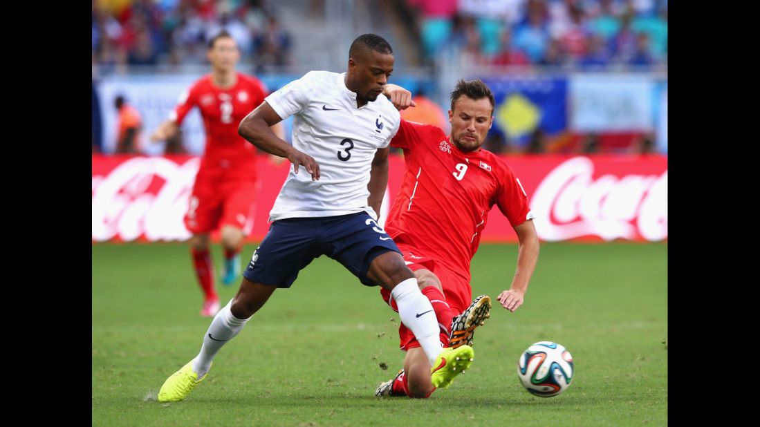 Evra and Switerland's Haris Seferovic battle for the ball.