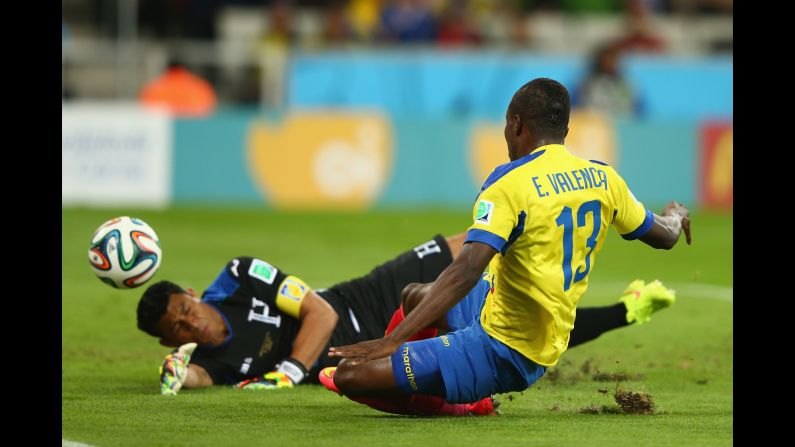 Enner Valencia of Ecuador scores the first goal of the game past Noel Valladares of Honduras.