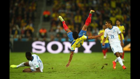 Jefferson Montero of Ecuador falls after a challenge by Maynor Figueroa of Honduras.