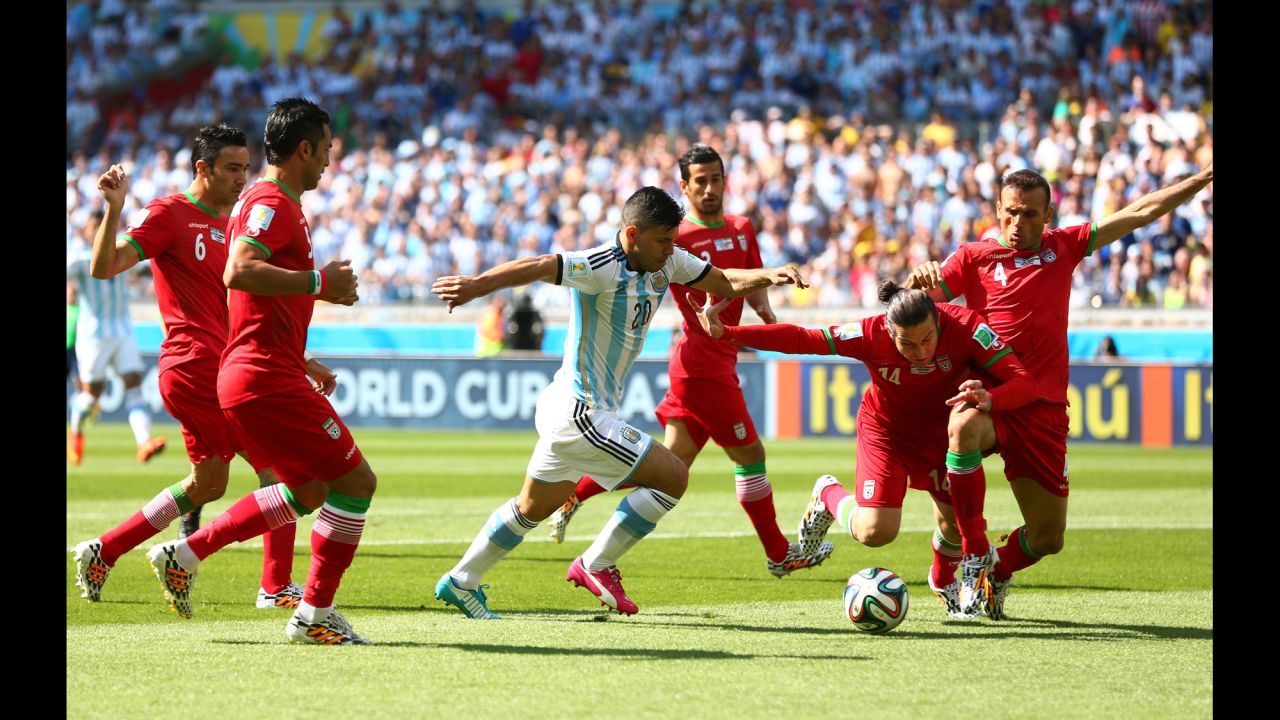 Sergio Aguero of Argentina competes for the ball against Iran.