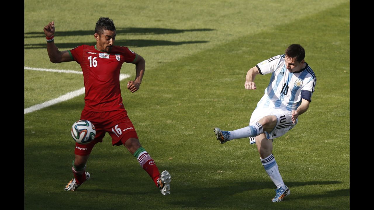 Messi, Argentina's captain, shoots past Iran forward Reza Ghoochannejhad for the goal. "They made the game very difficult for us," admitted Argentine coach Alejandro Sabella after his side's last-gasp victory.