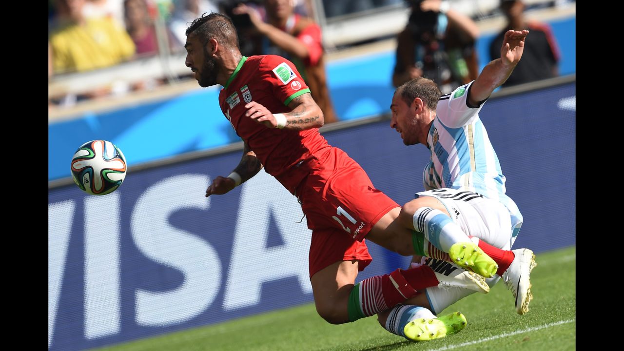 Iran forward Ashkan Dejagah, left, and Argentina defender Pablo Zabaleta collide. 