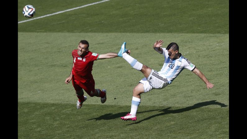 Iran defender Jalal Hosseini, left, and Argentina forward Sergio Aguero vie for the ball. 