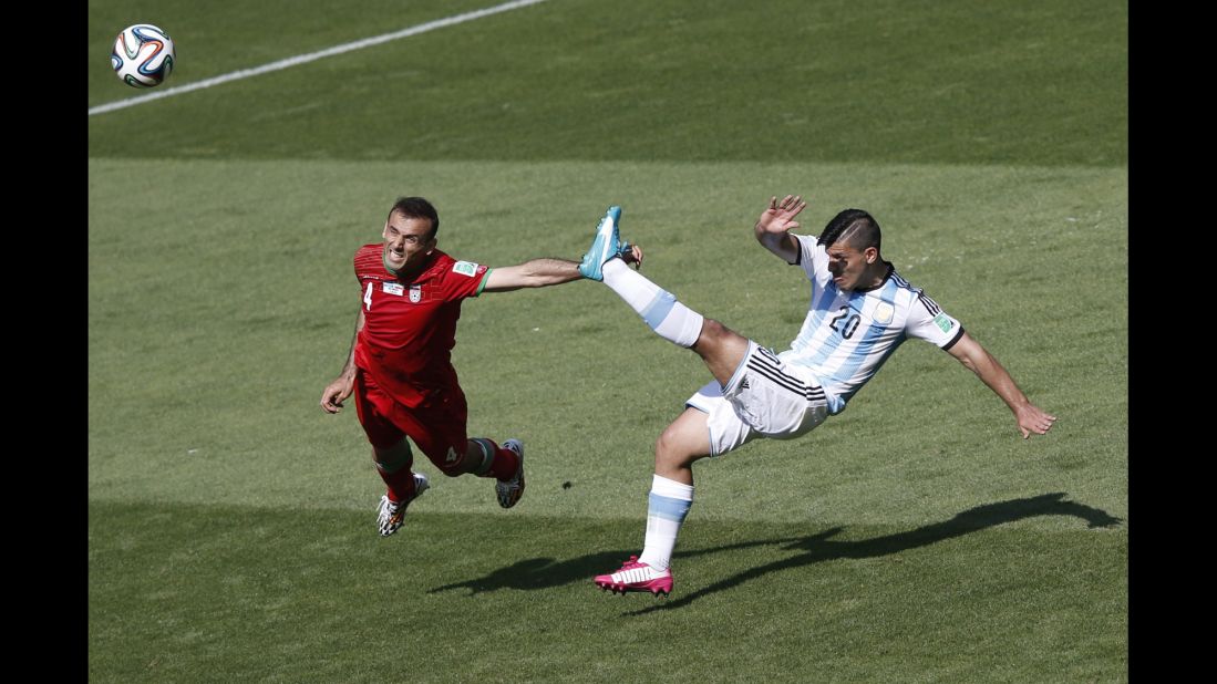 Iran defender Jalal Hosseini, left, and Argentina forward Sergio Aguero vie for the ball. 