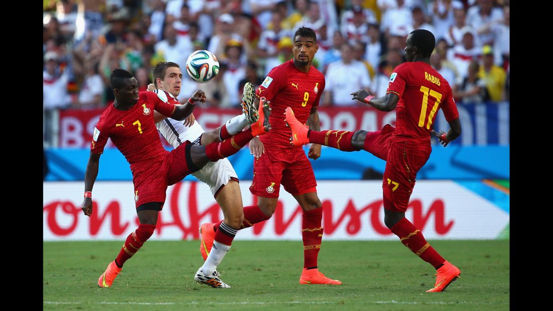 Philipp Lahm of Germany competes for the ball with Christian Atsu, left.