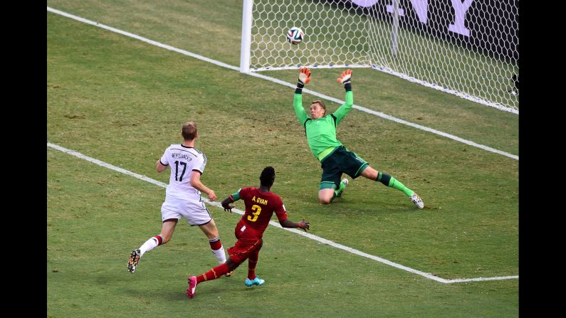 Asamoah Gyan of Ghana scores his team's second goal past Manuel Neuer, but Germany battled back to earn a 2-2 draw.