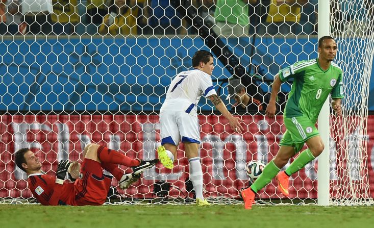 Nigeria forward Peter Odemwingie, right, shoots past Bosnia-Herzegovina goalkeeper Asmir Begovic, left, on Saturday, June 21, in Cuiaba, Brazil. Nigeria won 1-0.