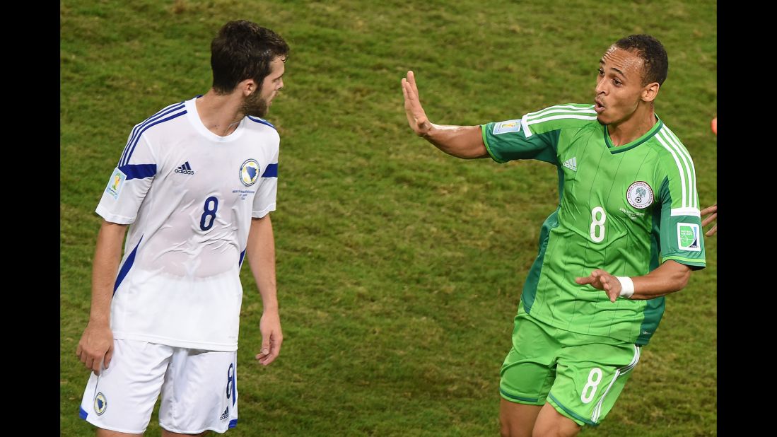 Nigeria forward Peter Odemwingie, right, celebrates near Bosnia midfielder Miralem Pjanic after scoring a goal.