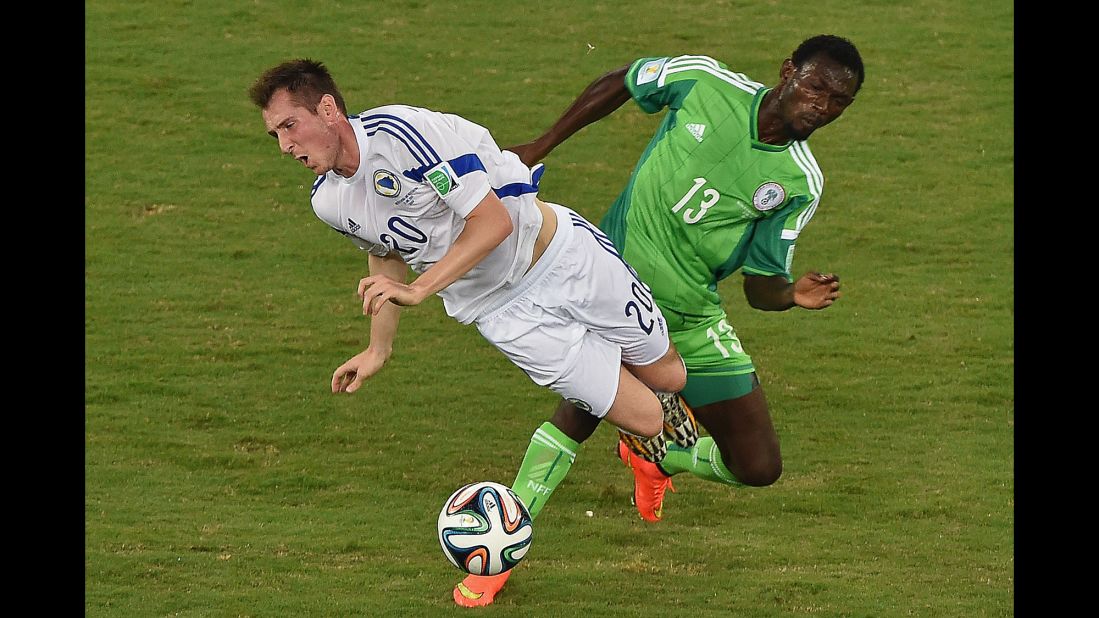 Nigeria defender Juwon Oshaniwa, right, challenges Bosnia-Herzegovina midfielder Izet Hajrovic.