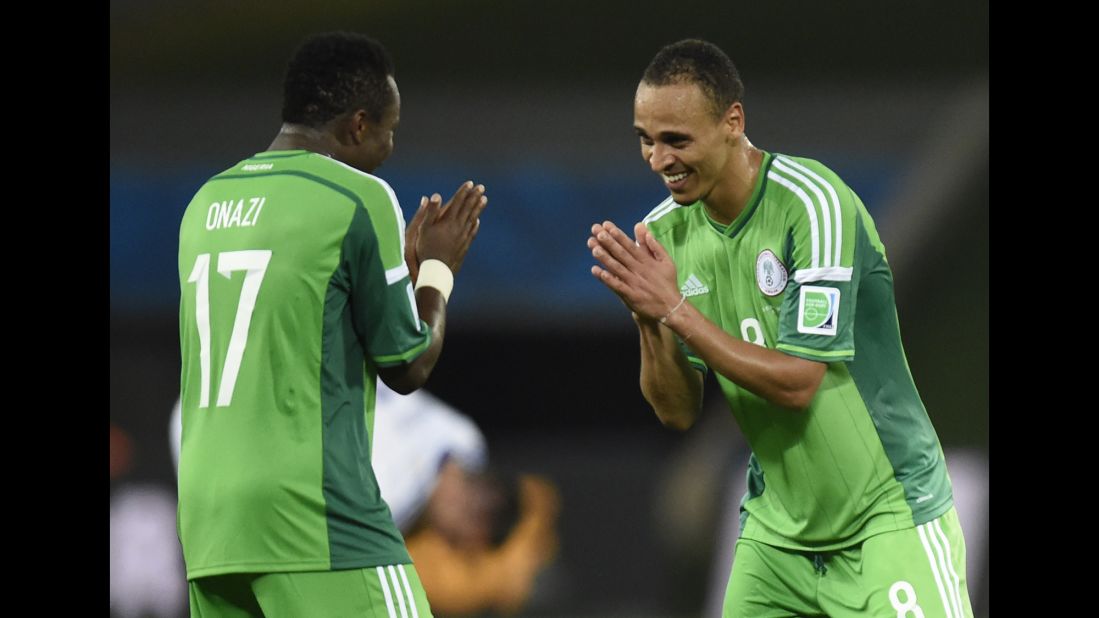 Nigeria midfielder Ogenyi Onazi, left, and forward Peter Odemwingie celebrate their win over Bosnia-Herzegovina in a World Cup match at Pantanal Arena in Cuiaba, Brazil, on Saturday, June 21. Nigeria won 1-0 and Bosnia was eliminated. 