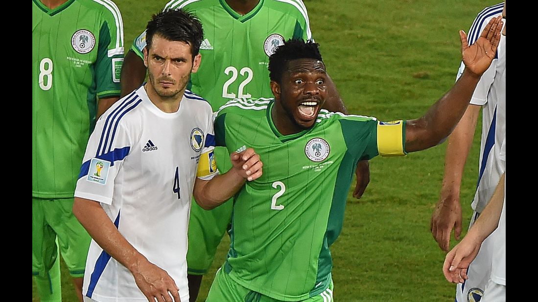 Nigeria defender Joseph Yobo gestures near Bosnia-Herzegovina defender and captain Emir Spahic.